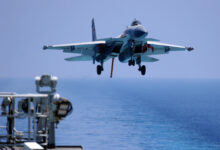 plane landing on an aircraft carrier